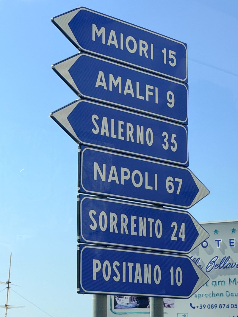 Road sign on the Amalfi Coast pointing to Maiori, Amalfi, Salerno, Napoli, Sorrento and Positano