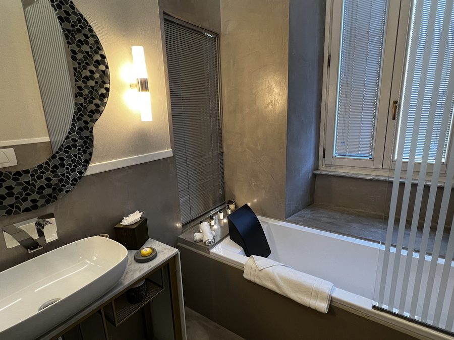 Soaking tub and stone vanity in the bathroom at Palazzo Manfredi