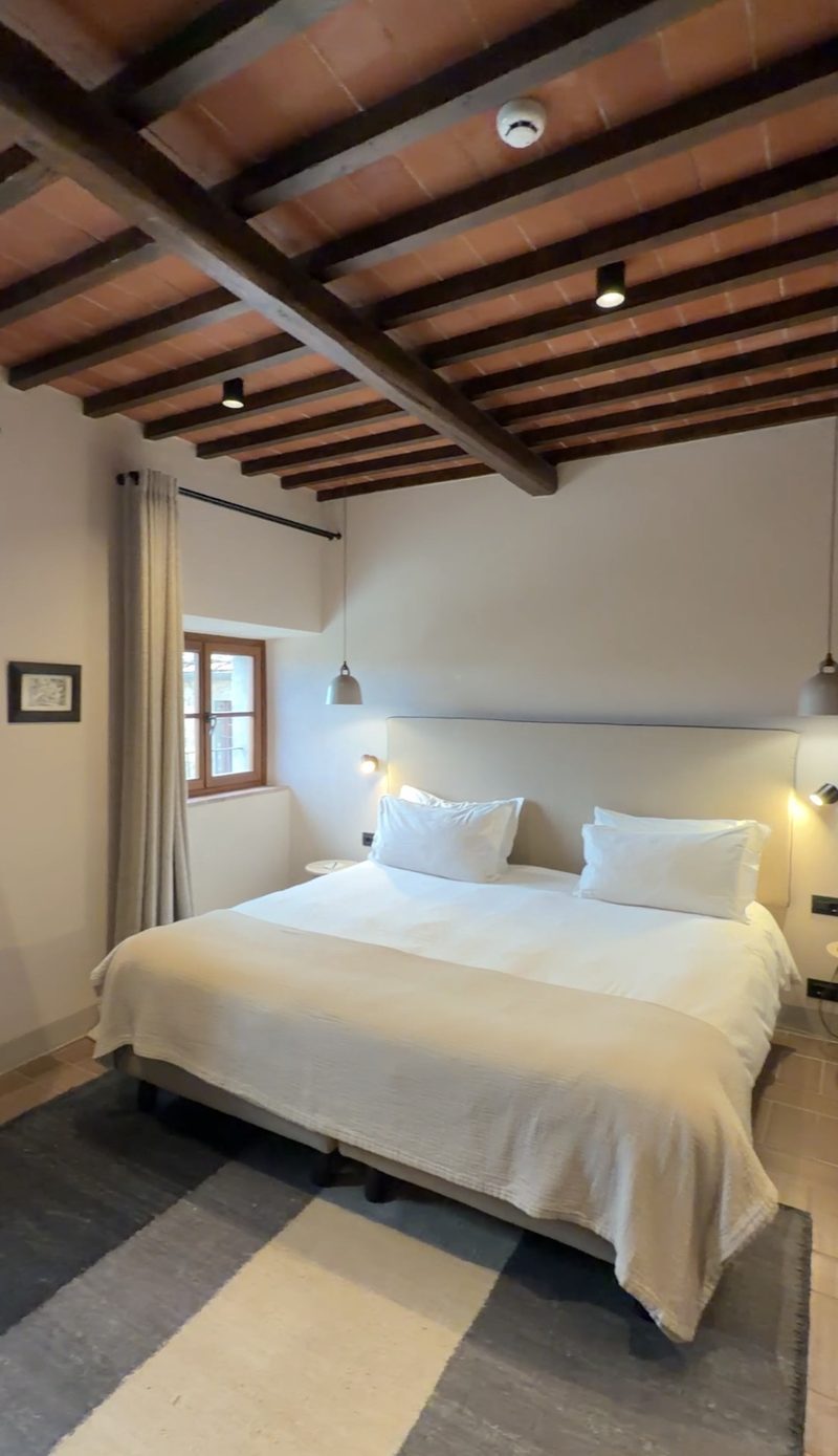 Bedroom with wood beam and terracotta ceiling at Pieve Aldina