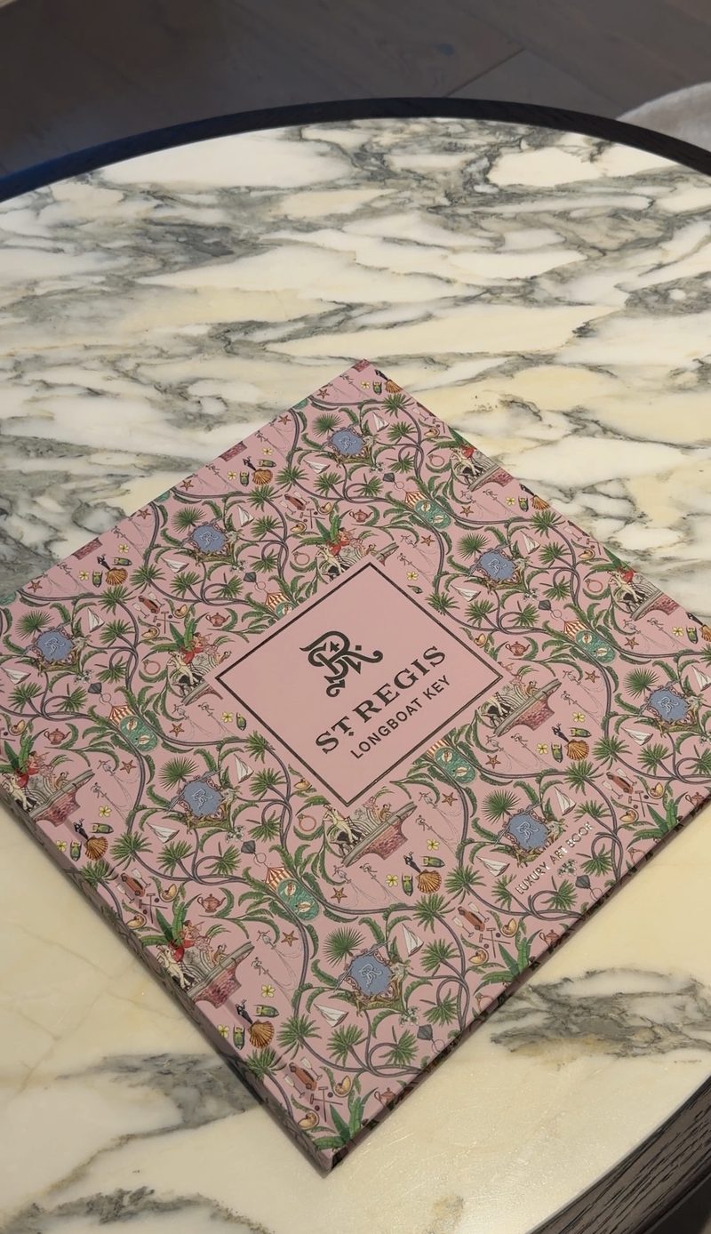 The St. Regis Longboat Key art book on a marble table
